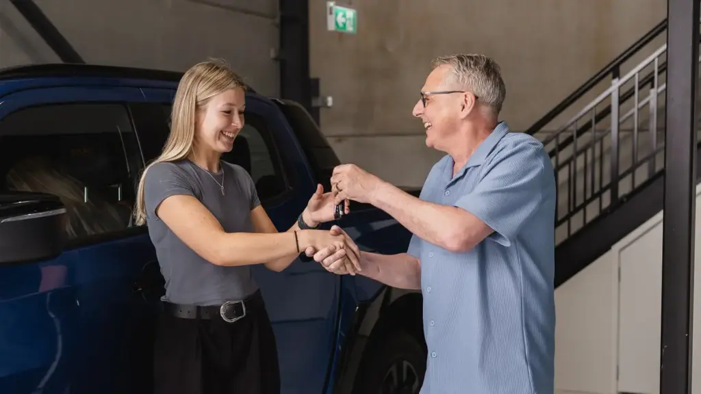Darren handing the keys for a new vehicle to a client.